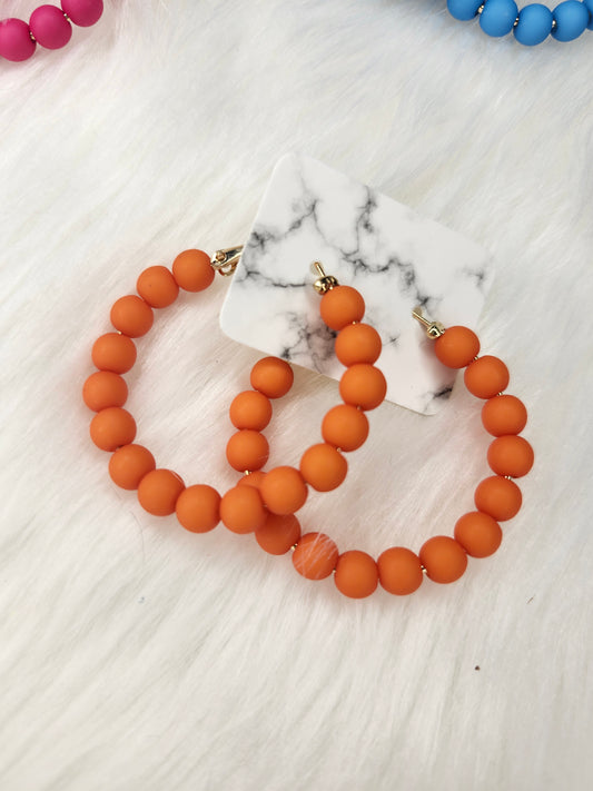 Bright orange bead hoop earrings