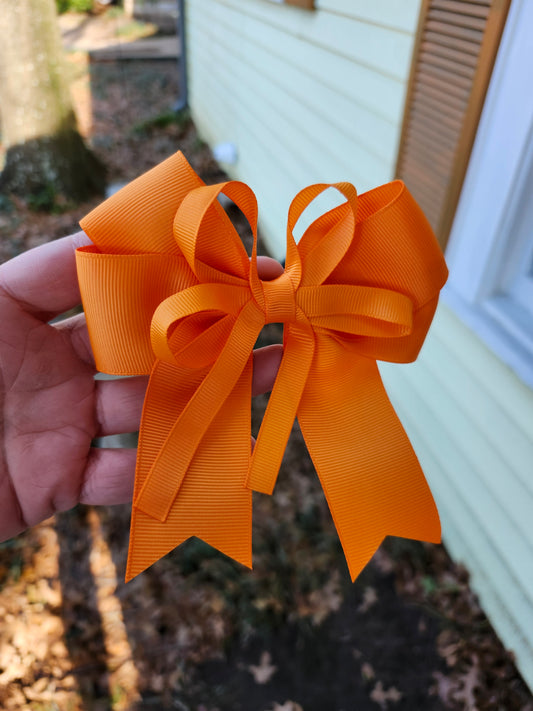 Small orange cheer bow