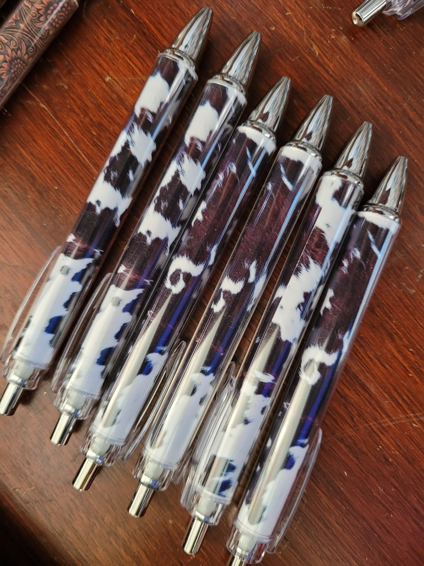 Brown and white cow print pens