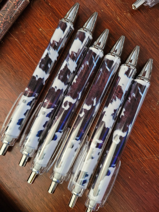 Brown and white cow print pens